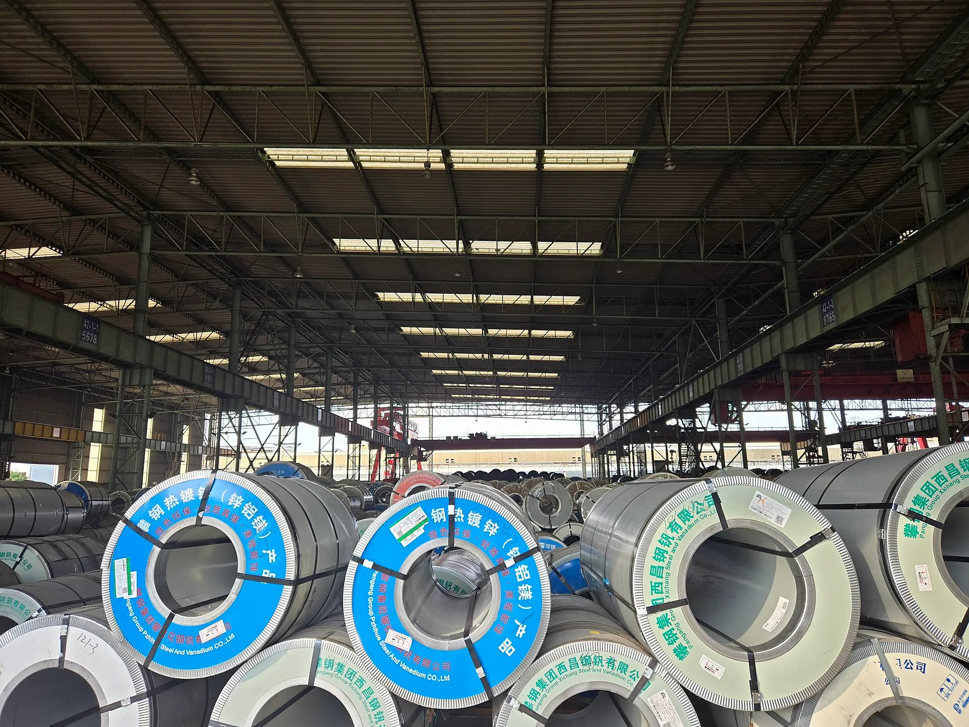 Steel coils stacked in a factory warehouse
